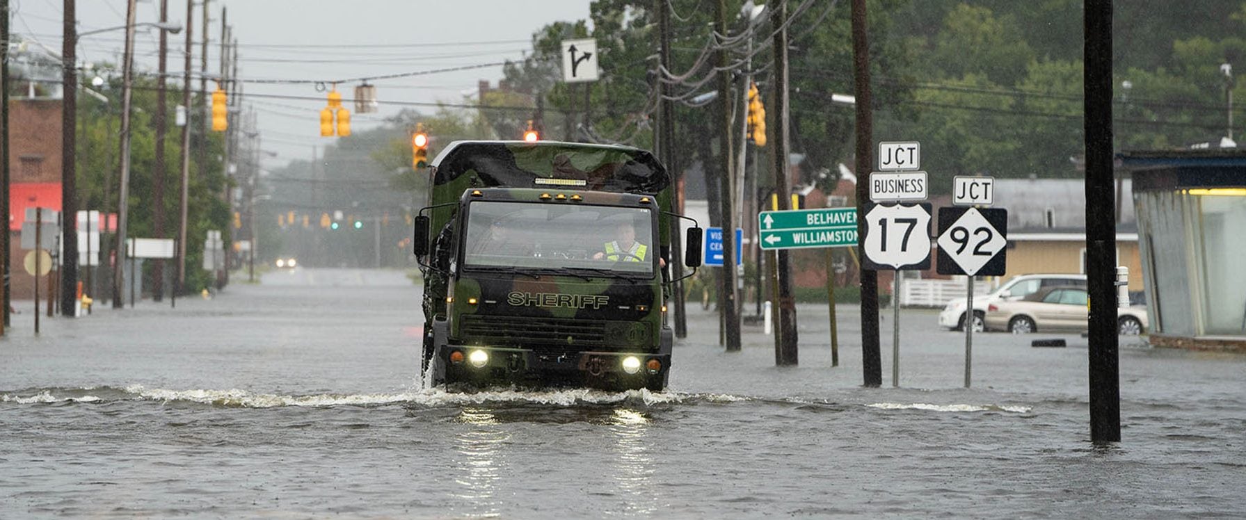 A sheriff’s department truck drives through floodwaters during Hurricane Florence in Washington, N.C. in 2018. New courses offered by the ECU College of Nursing will prepare advanced nurses to lead communities and health care organizations to quickly find solutions and reduce suffering during natural disasters. (Photo by Cliff Hollis)