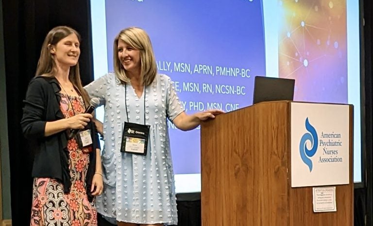 Susan Lally and Alexis Spence on stage at the American Psychiatric Nurse Association conference in Long Beach, California Oct. 19-22.