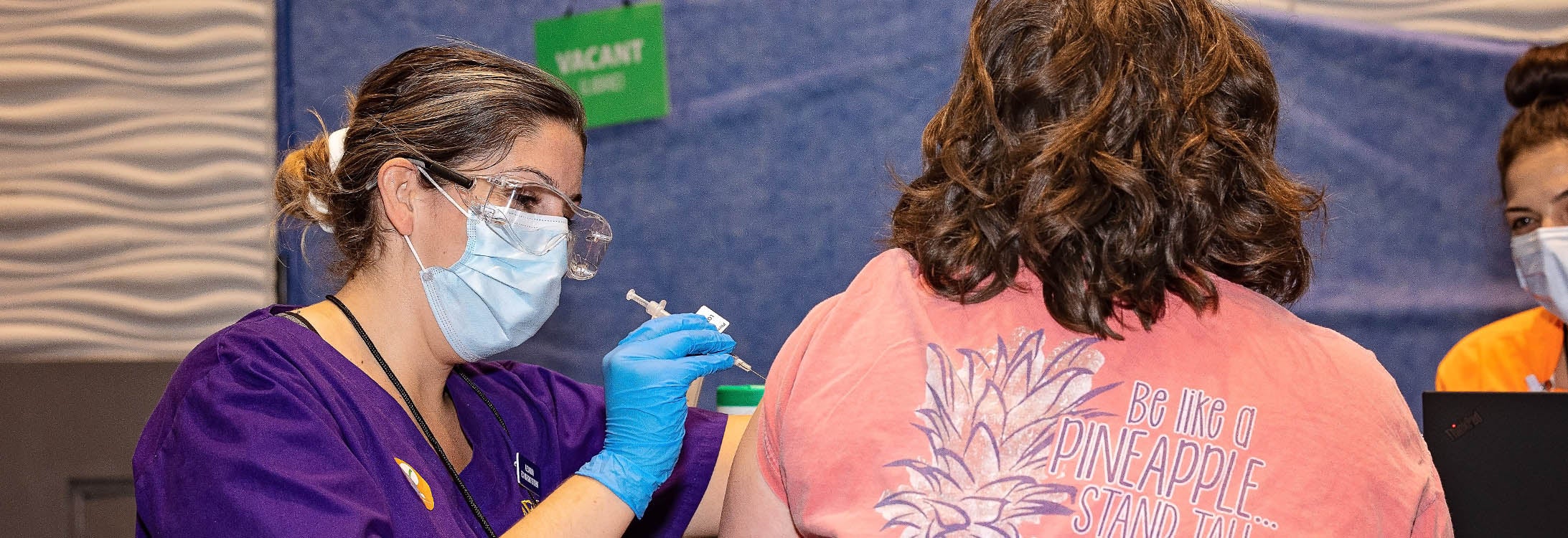ECU Nursing student Alex Yllanes gives COVID-19 vaccines during a clinic event at the Greenville Convention Center on March 22, 2021.