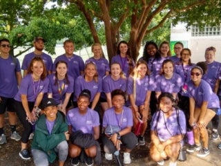 A group of students taking a photo under a tree