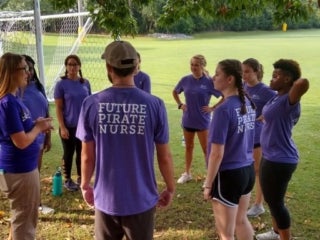 A group of students in a circle talking to councilors