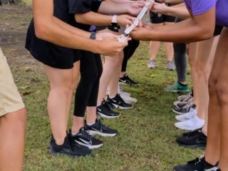 Students standing in two lines completing a group task