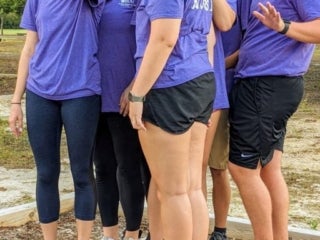 a group of students standing on a small raised wooden platform