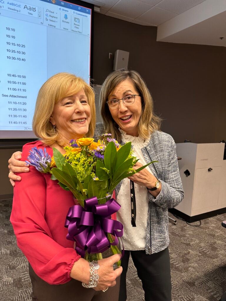 Dr. Susan Kidd receives flowers during a recognition of her time at the College of Nursing.