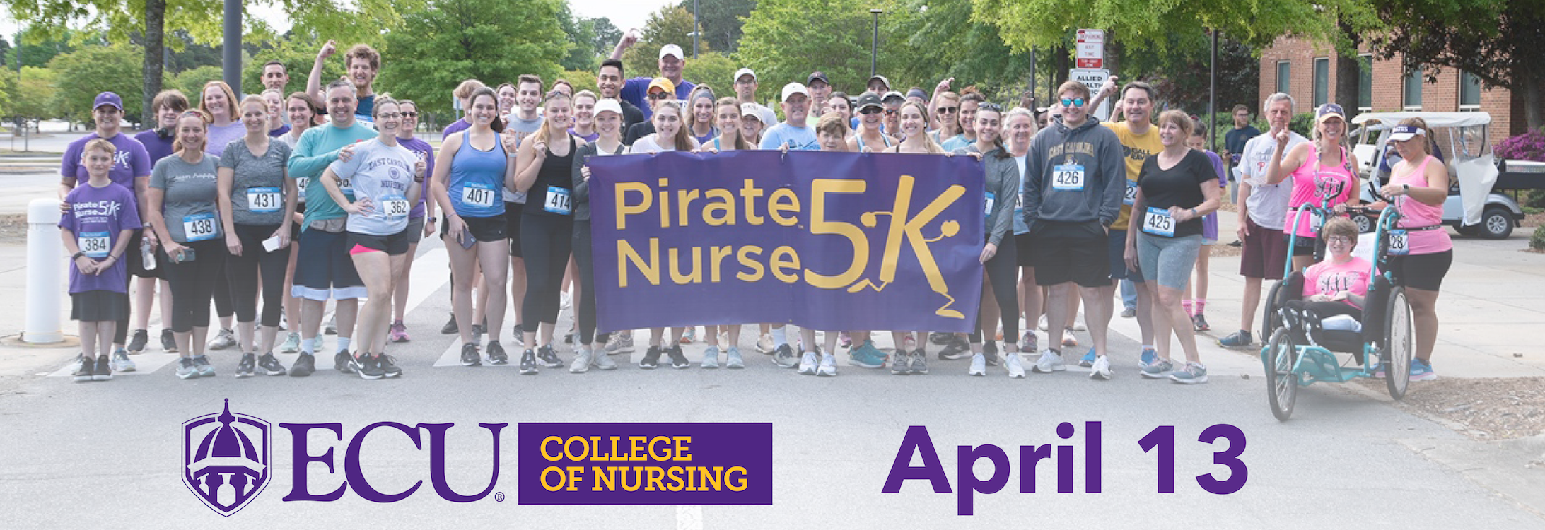 A group of people hold a banner during the 2023 Pirate Nurse 5K race